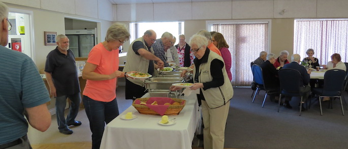 There was, however a hungry bunch of  members who got their lunch early under the watchful eye of our caterer, Ernie Isaac, who always makes sure there is enough good food. 