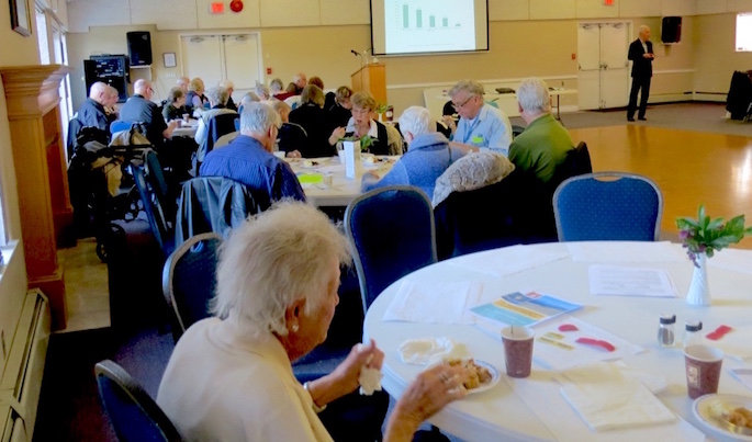 The group on the left side of the hall were very intent on studying the information provided as part of the program.