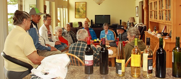George organizes the most interesting games each year!  This year it was a wine game played with 12 bottles of wine plus a prize for everyone.  As the numbers were drawn everyone received one of those prizes seen on the right side of the picture above.  In addition, 3 of the first 9 people also received a bottle of wine.  The last 3 numbers drawn were the grand prize winners of not only a prize, but 3 bottles of wine each! 